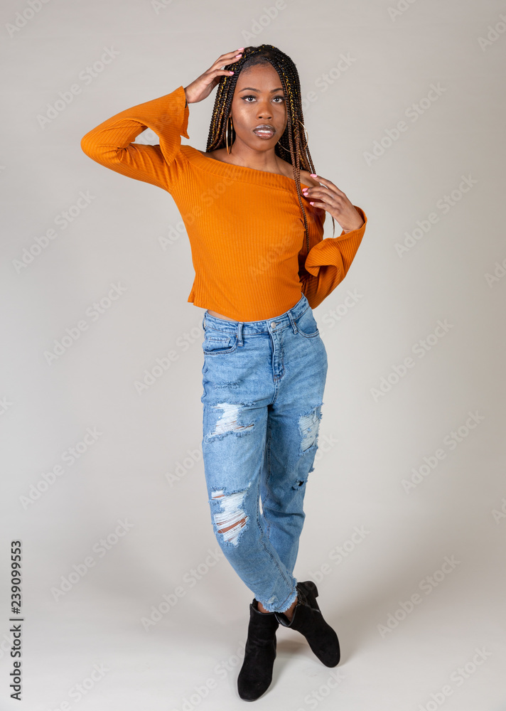 Young Black Woman posing in studio with Vintage 90s style casual urban  outfit Stock Photo | Adobe Stock