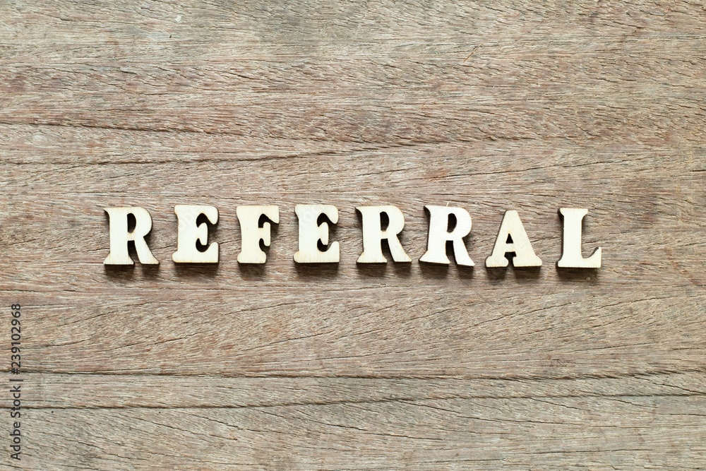 Letter block in word referral on wood background Letter block in word referral on wood background