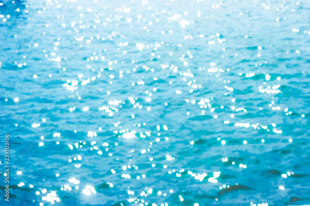 Fototapeta premium Abstract bokeh sunlight background with summer blue sea.