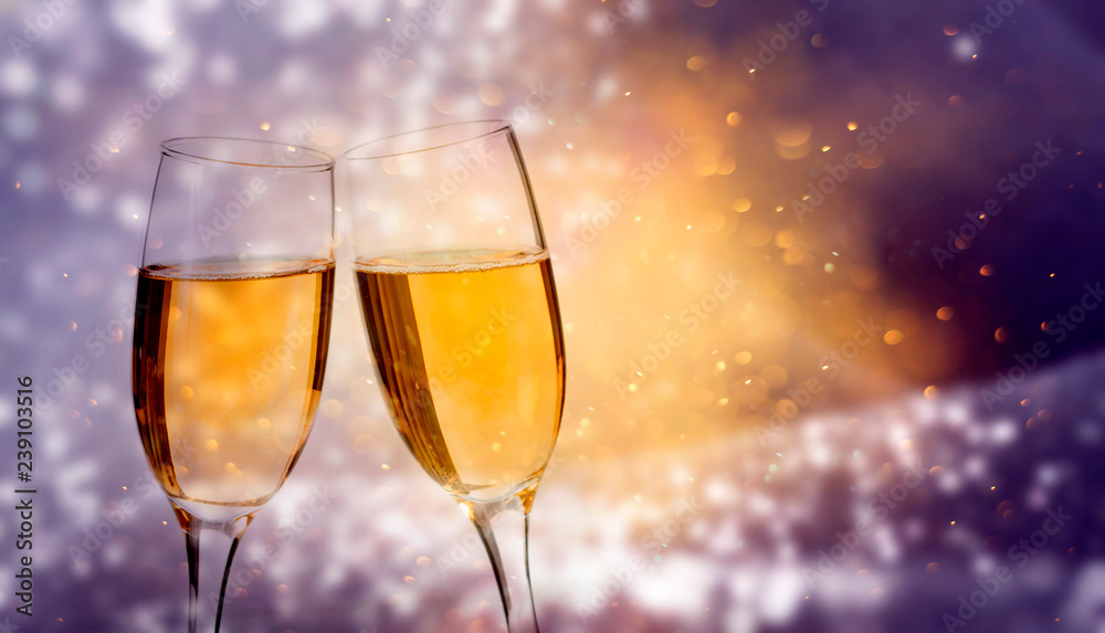 Glasses of champagne against holiday lights Glasses of champagne against holiday lights