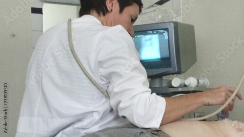 Wallpaper Mural Doctor in white robe performs ultrasound examination of the female breast in the clinic. Scanning of a breast of the adult woman Torontodigital.ca