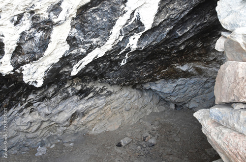 Tibet. Stoned entrance to small cave on the shore of Rakshas Tal lake photo