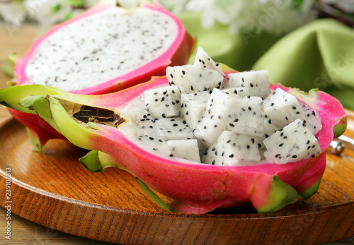Ripe sweet tropical dragon fruit on a wooden plate