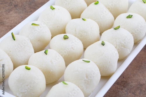 Indian Sweet Rasgulla Also Know as Rosogolla, Roshogolla, Rasagola, Ras Gulla, Anguri Rasgulla or Angoori Rasgulla is a Syrupy Dessert Popular in India. It is Made From Ball Shaped Dumplings photo