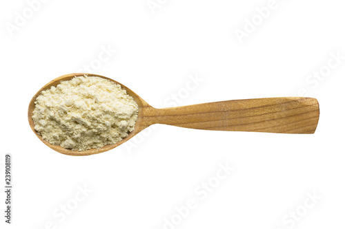 fenugreek powder in wooden spoon isolated on white background. spice for cooking food, top view.