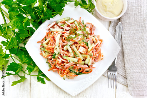 Salad of sausage and spicy carrots with mayonnaise on table top