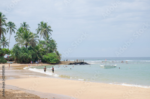The landscape the beautiful ocean coast in Sri Lanka with palm trees and people © rosetata