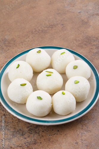 Indian Sweet Rasgulla Also Know as Rosogolla, Roshogolla, Rasagola, Ras Gulla, Anguri Rasgulla or Angoori Rasgulla is a Syrupy Dessert Popular in India. It is Made From Ball Shaped Dumplings photo