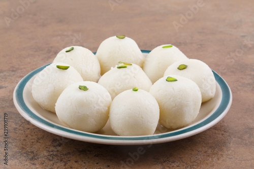 Indian Sweet Rasgulla Also Know as Rosogolla, Roshogolla, Rasagola, Ras Gulla, Anguri Rasgulla or Angoori Rasgulla is a Syrupy Dessert Popular in India. It is Made From Ball Shaped Dumplings photo