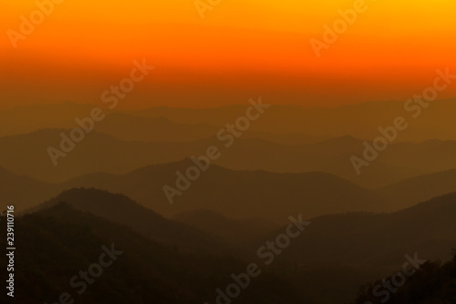 Dramatic sunset and sunrise sky and clouds over blue mountains layers © jaboo_foto