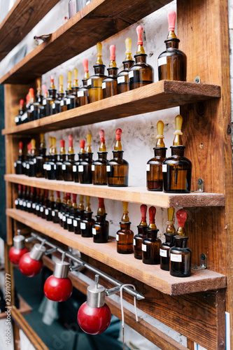 Chemical worker, Chemistry, Experiment, Vials. Close up amber color bottles on the shelf in old perfume laboratory. Flasks and examples of odor in the perfume shop.