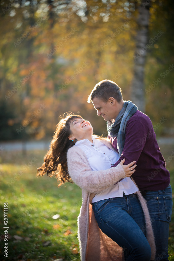 A man tilts a woman to dance in the autumn park A man tilts a woman to dance in the autumn park