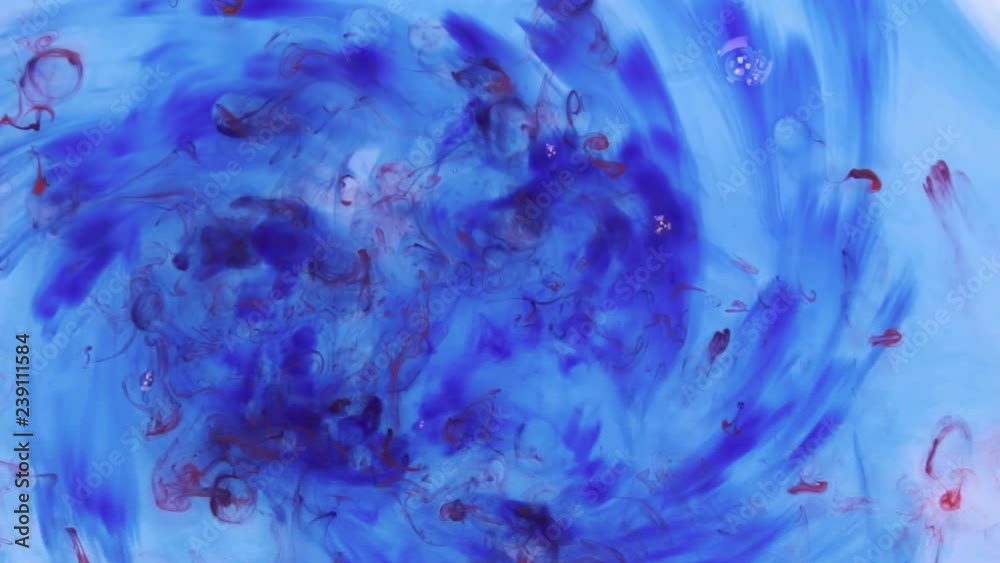 Falling a drop of red paint into the water with blue ink. Falling a drop of red paint into the water with blue ink.