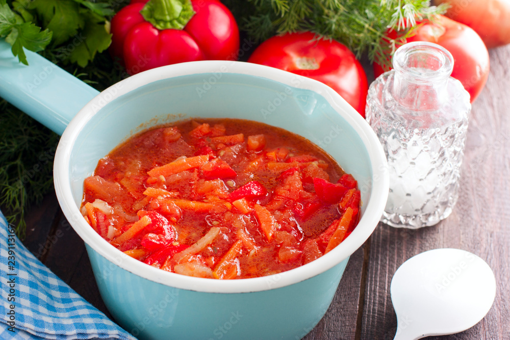 Letcho with tomatoes, peppers and carrots in an enamelled ladle, horizontal Letcho with tomatoes, peppers and carrots in an enamelled ladle, horizontal