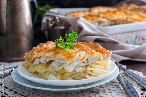Sliced puff pastry cake with chicken, potatoes and onions, selective focus