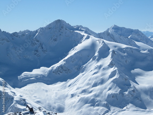 Snow-capped mountain peaks of mount Cheget bright Sunny day