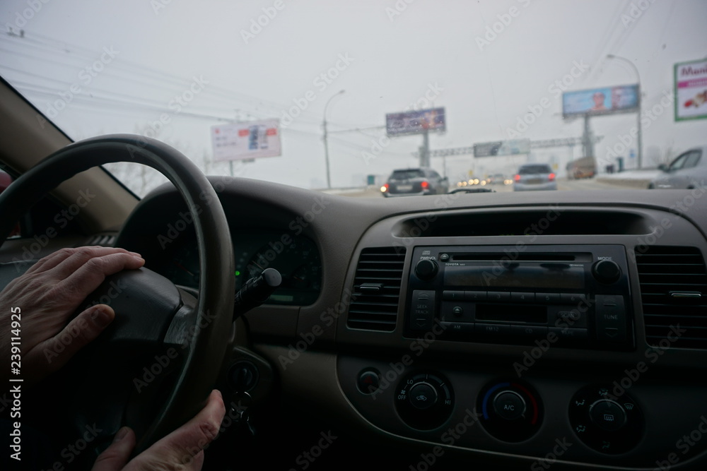 car steering wheel, dashboard, man's hand