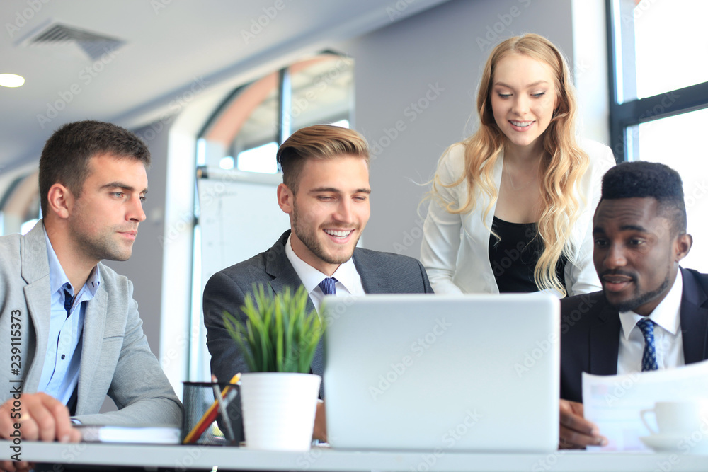 Startup business team on meeting in modern bright office interior and working on laptop. Startup business team on meeting in modern bright office interior and working on laptop.