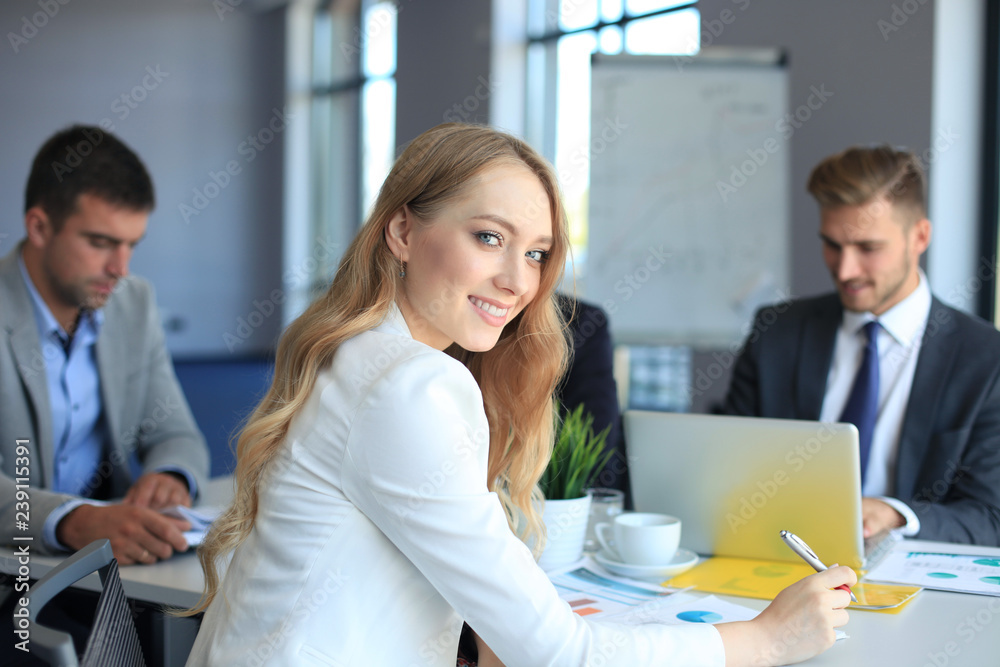 business woman with her staff, people group in background at modern bright office indoors. business woman with her staff, people group in background at modern bright office indoors.