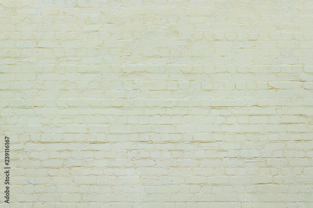 Fototapeta premium Yellow brick wall background. brick wall of colored stone texture