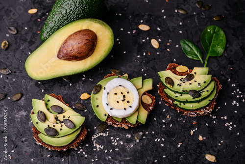 Food, avocado, healthy food. Avocado sandwiches with seeds, sesame and a lime. It can be used as a background
