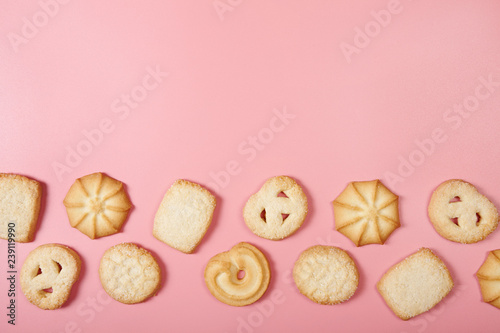 Danish butter cookies on pink background with copy space. Top view. photo