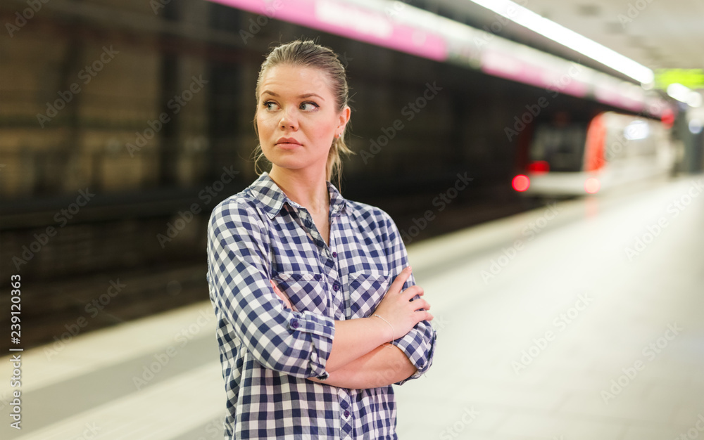 Girl waiting for train at metro station