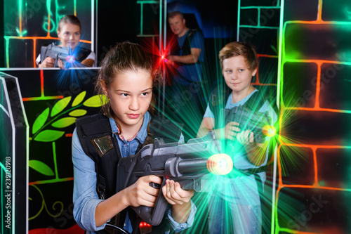 Portrait of teenager girl with laser gun having fun with her fam © JackF