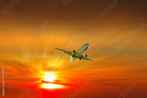 Airplane on sunrise background