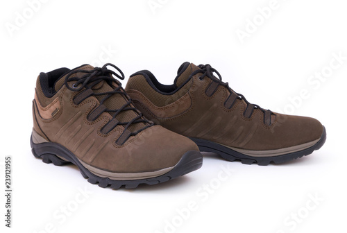 Closeup of a pair of unbranded brown trekking shoes isolated on white background