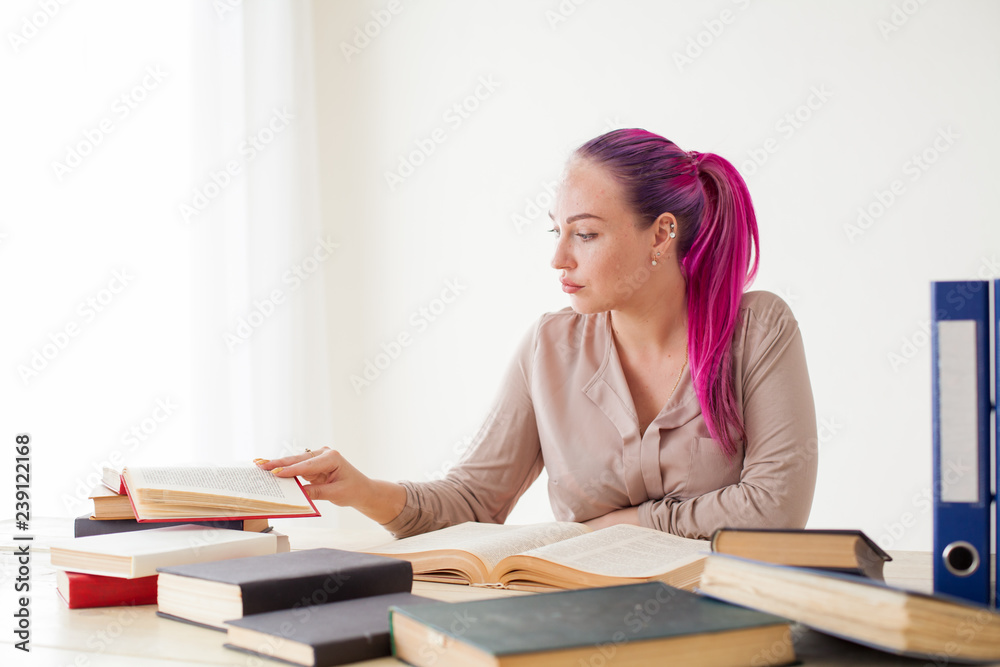 beautiful business woman working in an Office behind a table with books beautiful business woman working in an Office behind a table with books