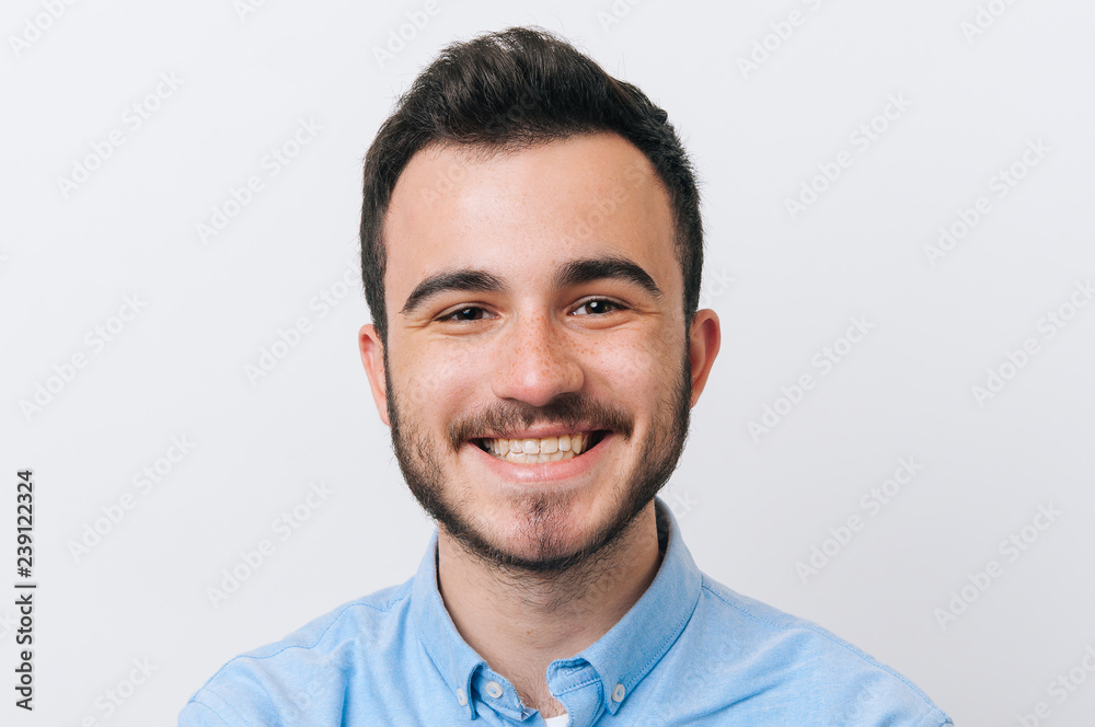 A smiling face of young man over white background