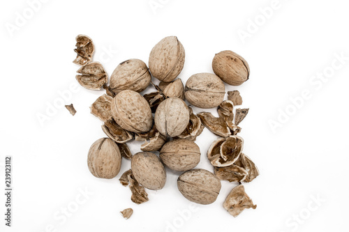 Walnuts on a white background, broken by a nutcracker