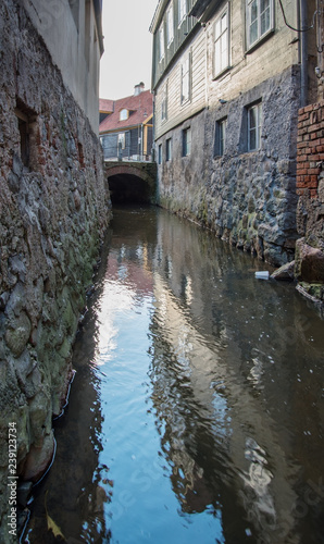 River between houses in old town.