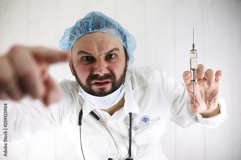Crazy bearded doctor in a white coat and old syringe Crazy bearded doctor in a white coat and old syringe