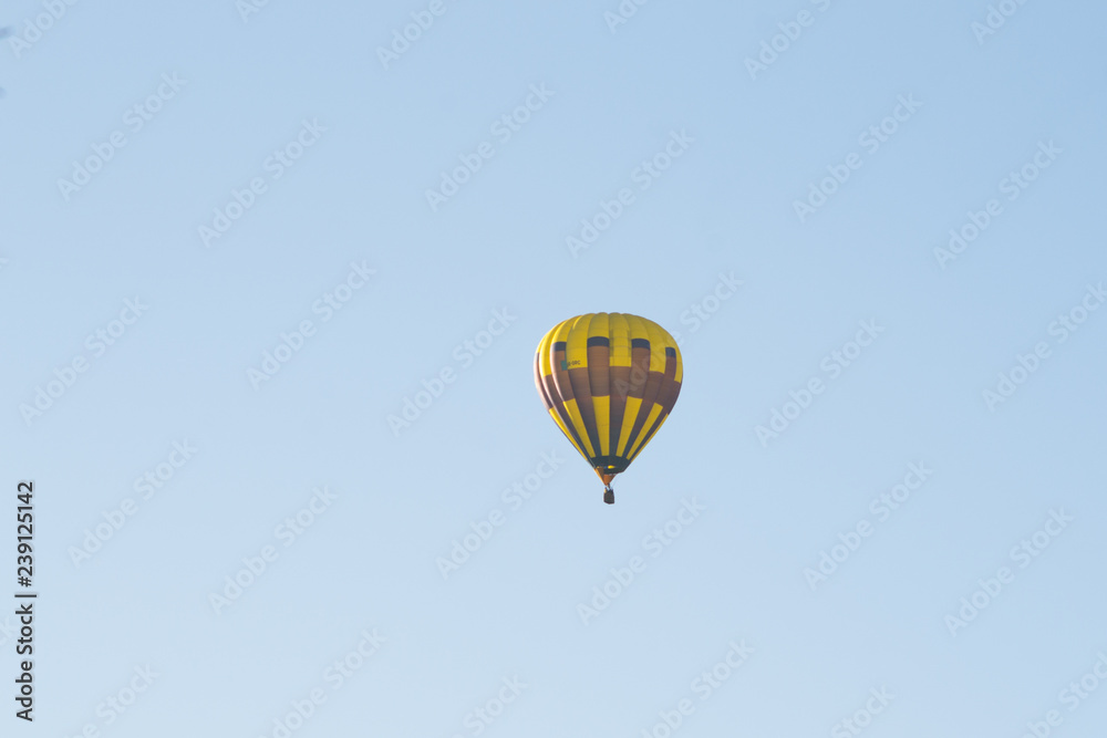 Yellow balloon against a blue sky. Aerostat. People in the basket. Fun. Summer entertainment. Romantic adventures. Yellow balloon against a blue sky. Aerostat. People in the basket. Fun. Summer entertainment. Romantic adventures.