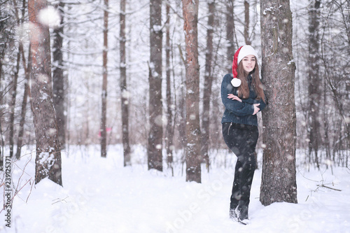 Girl in a winter park in snowfall