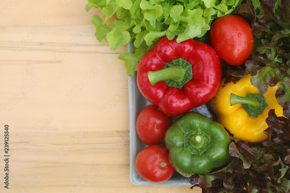Top view of organic fresh vegetables in ceramic plate on wooden table. Preparation for healthy food. Top view of organic fresh vegetables in ceramic plate on wooden table. Preparation for healthy food.