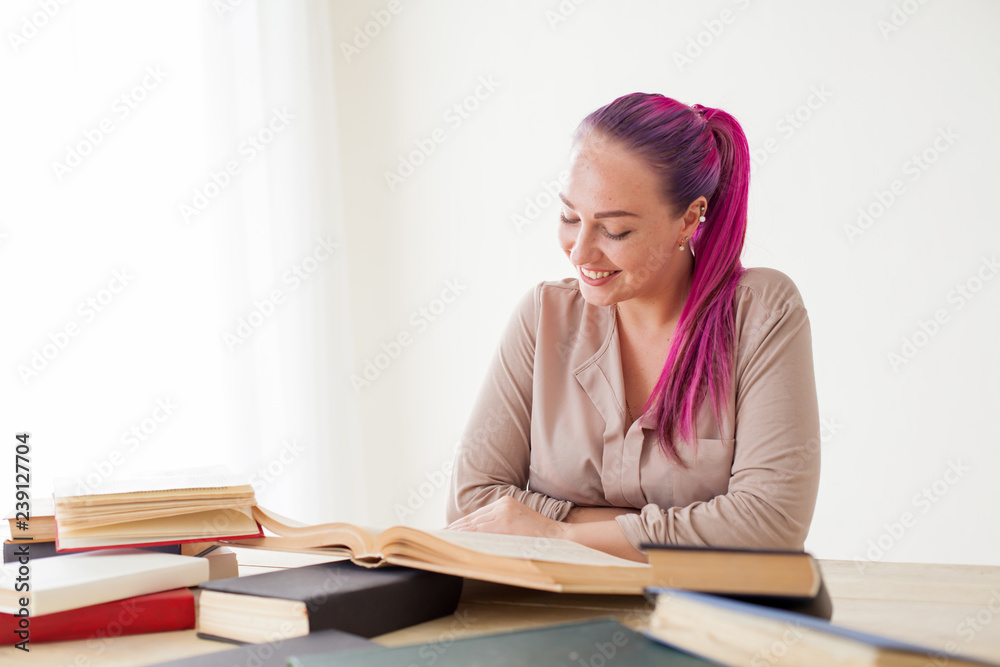 beautiful business woman working in an Office behind a table with books beautiful business woman working in an Office behind a table with books