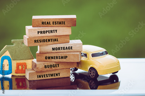 Home Car for mortgage and real estate concept: House vehicle model with wooden blocks for letter e.g investment,budget,ownership,residential,property etc. Idea show management financial for dream life