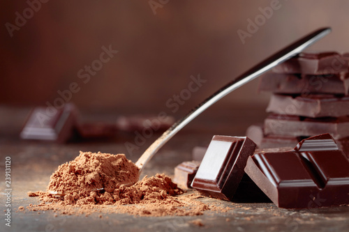 Broken  chocolate pieces and cocoa powder .