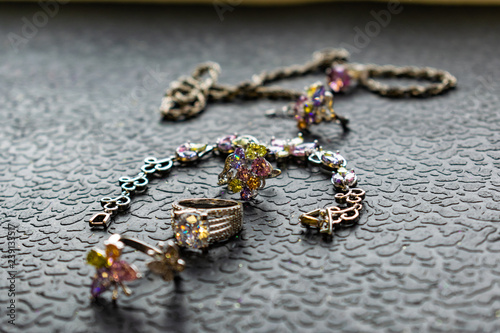 Silver jewelry with colored stones-cubic Zirconia of different colors, delicate shades. Jewelry pink, green, yellow and lilac. Rhinestones on metal products. Women's fashionable and stylish image.