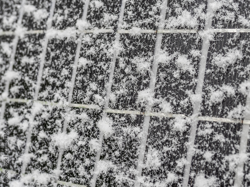 solar cells covered up in snow during winter time producing less electricity perspective view
