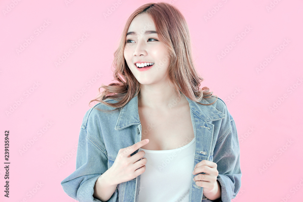 Asian woman surprised with special deals & discounts of promotions, blue jean clothing, pink background Asian woman surprised with special deals & discounts of promotions, blue jean clothing, pink background