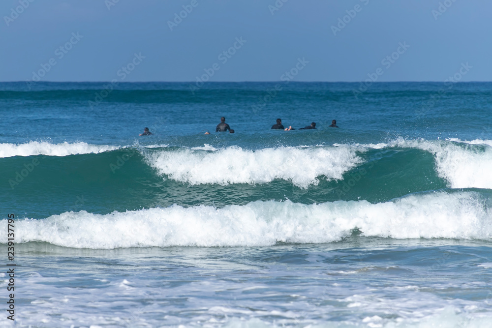 Surfers catching a wave. Foam coastal waves. Mediterranean Sea. Israel Surfers catching a wave. Foam coastal waves. Mediterranean Sea. Israel