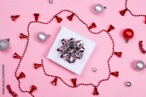 Giftbox with decoration accessories on pink background.