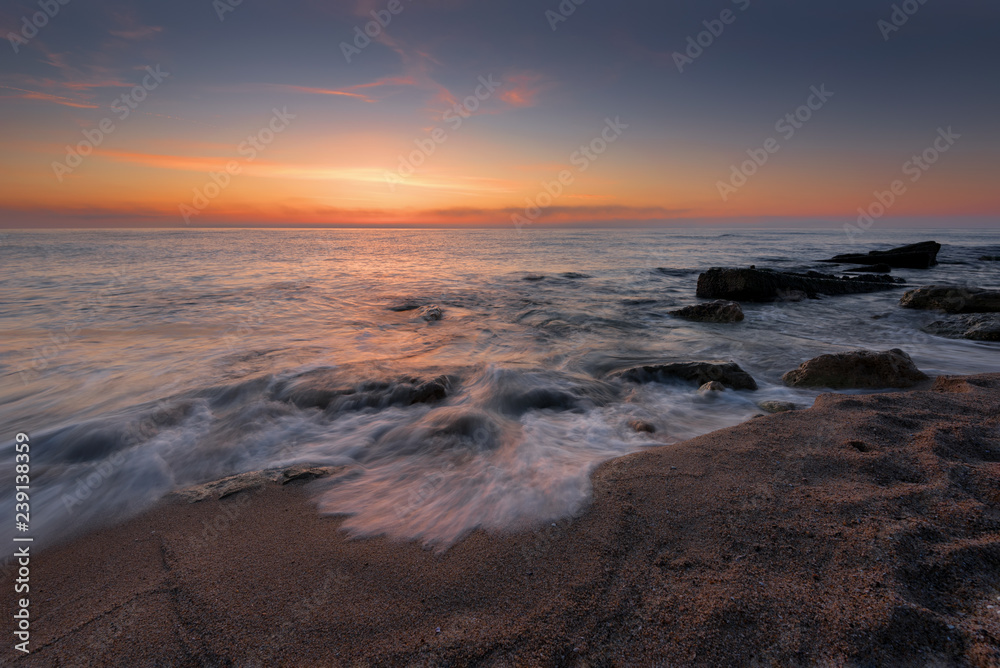 Seascape during sunrise. Beautiful natural seascape, blue hour. Sea sunrise at a Black coast near Varna, Bulgaria. Magnificent sunrise with clouds in the middle of April.
