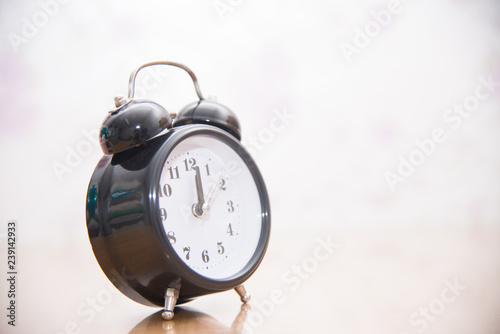 Vintage clock on blurred background.