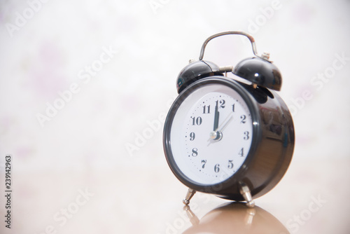 Vintage clock on blurred background.