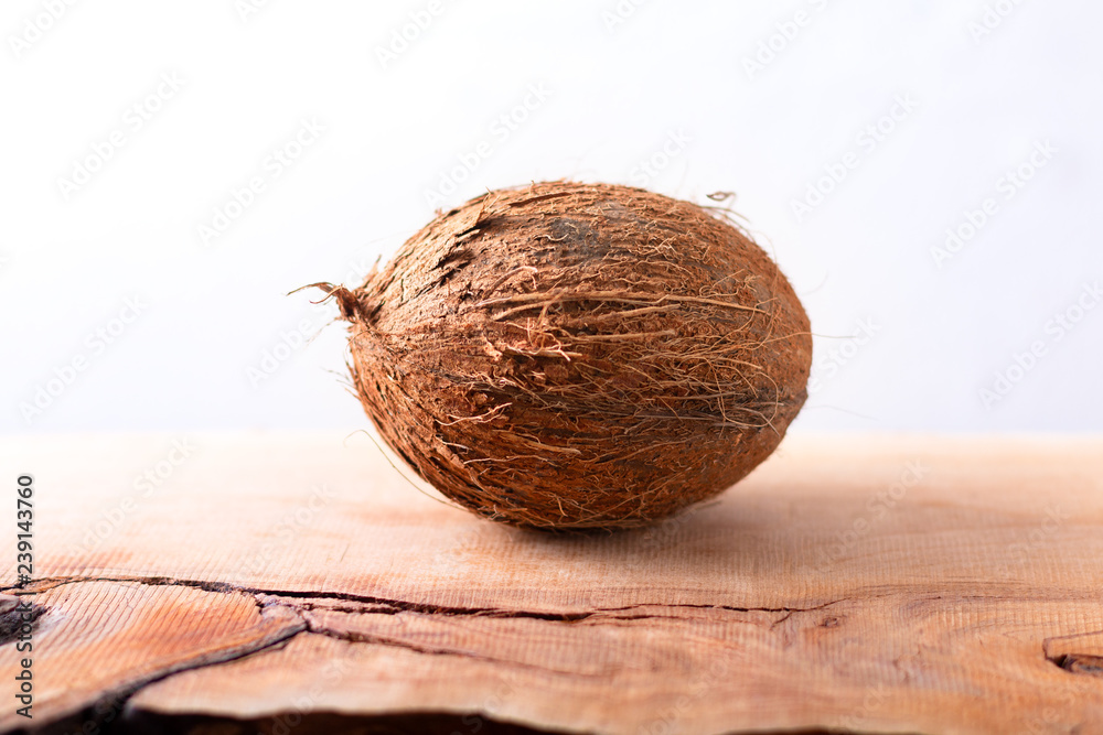 Whole single organic Tropical coconut fruit on wodden background with copy space Whole single organic Tropical coconut fruit on wodden background with copy space
